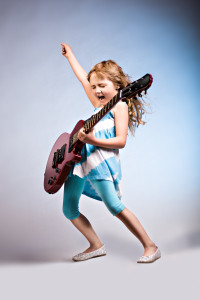 portrait of young girl with a guitar on the stage